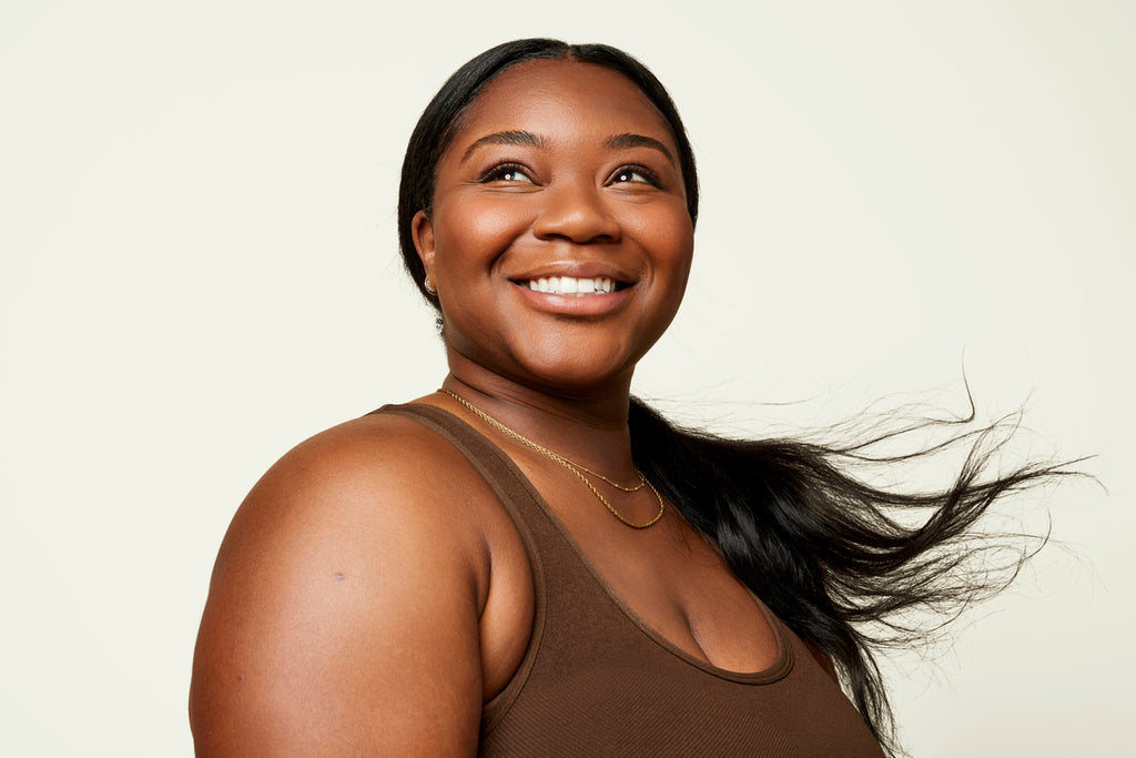 Black woman with long, straight hair in a ponytail