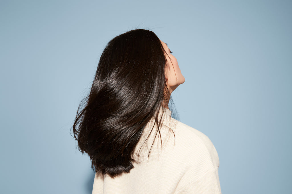 A woman with shiny, healthy black hair