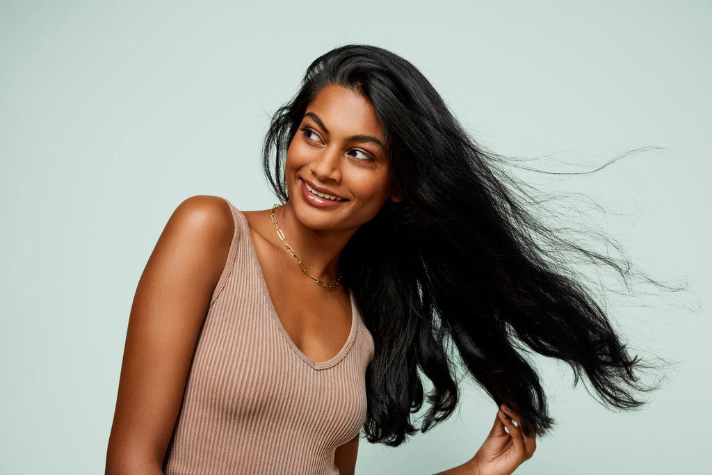 Woman with long black hair blowing in the wind