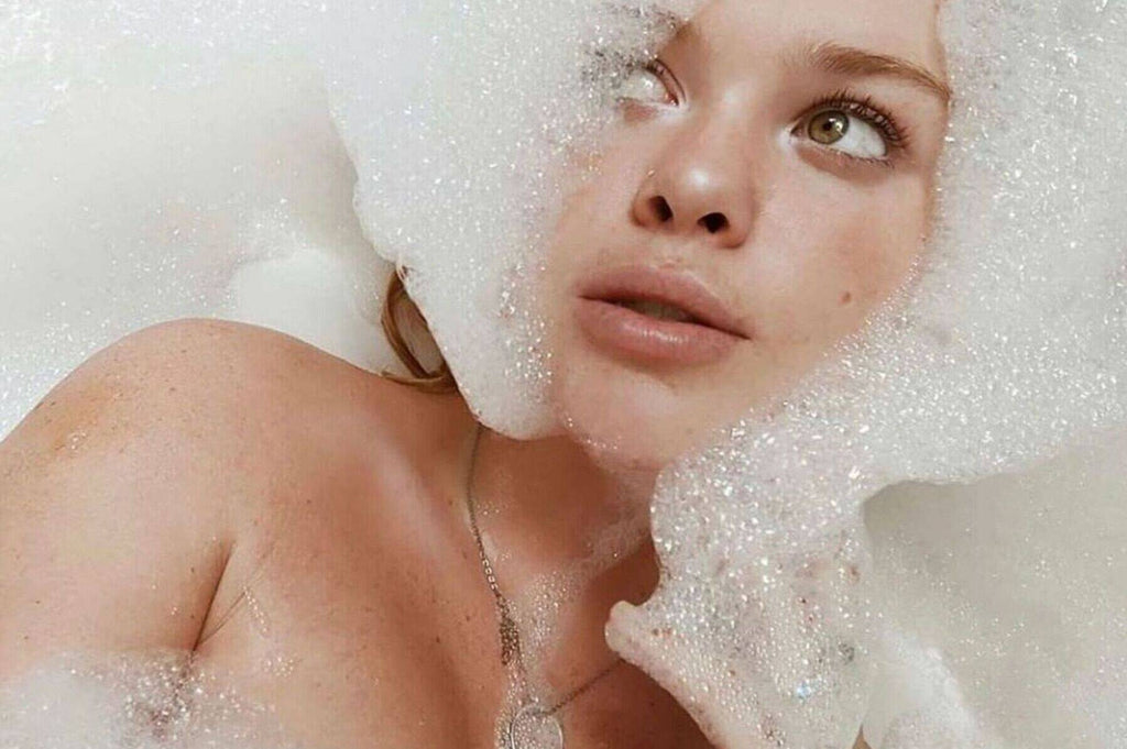 Woman with soap suds framing her face