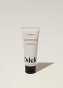 A tube of Odele Air Dry Styler stands upright against a plain, light-colored backdrop with the front of the label facing the camera.