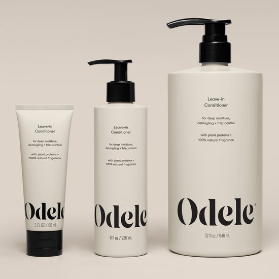 Three bottles of Leave-in Conditioner (2 fl oz, 8 fl oz, and 32 fl oz) are arranged side by side on a neutral background. Each bottle features a simple, modern design with black text.