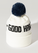 The Good Hair Day Winter Hat is a white knit beanie with a dark blue pom-pom and GOOD HAIR in bold black letters on the front. This limited-edition hat is made in Minnesota for cozy comfort all winter.