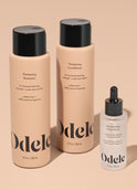 The Odele Beauty Thickening Set is displayed standing upright on a plain light orange background.