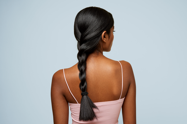 A woman with a long, thick braid of hair down her back