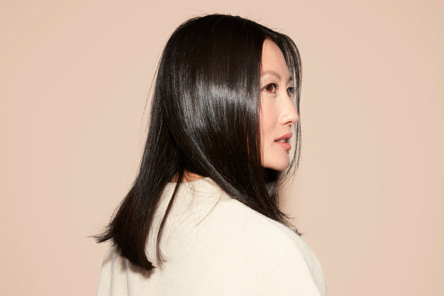 Side profile of a woman with shiny straight black hair