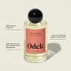 Odele Hair + Body Mist comes in a clear bottle with a black cap and coral label, offering a natural, gender-neutral fragrance with bergamot leaf and hydrating botanicals.