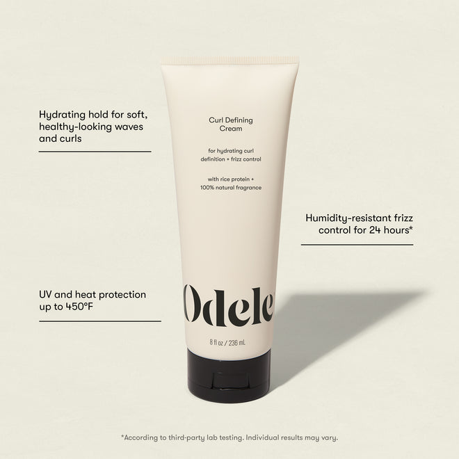 A tube of Curl Defining Cream stands upright on a light background. Text highlights its hydrating formula, UV and heat protection up to 450°F, and 24-hour humidity-resistant frizz control for salon-grade results.