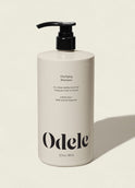 A 32 fl oz (946 ml) beige bottle of Clarifying Shampoo Bulk with chelation technology and a black pump, showcasing minimalist black text, stands upright on a light background. The shampoo is sulfate-free.