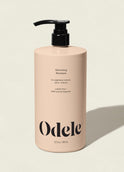 A beige bottle of Volumizing Shampoo Bulk with a black pump sits on a light background. The label highlights its salon-grade volume, weightless moisture, and 100% natural fragrance.