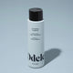 A bottle of Odele Curl Defining Conditioner stands upright against a plain, light blue backdrop with the front of the label facing the camera.