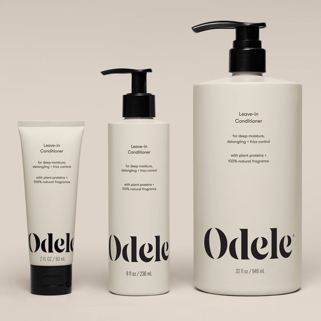 Three bottles of Leave-in Conditioner (2 fl oz, 8 fl oz, and 32 fl oz) are arranged side by side on a neutral background. Each bottle features a simple, modern design with black text.
