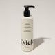 A bottle of Odele Leave-in Conditioner stands upright against a plain, light-colored backdrop with the front of the label facing the camera.