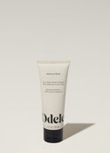 A tube of Odele Moisure Mask stands upright against a plain, light-colored backdrop with the front of the label facing the camera.