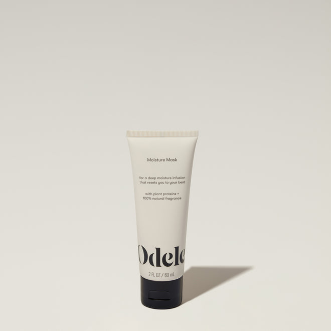 A tube of Odele Moisure Mask stands upright against a plain, light-colored backdrop with the front of the label facing the camera.