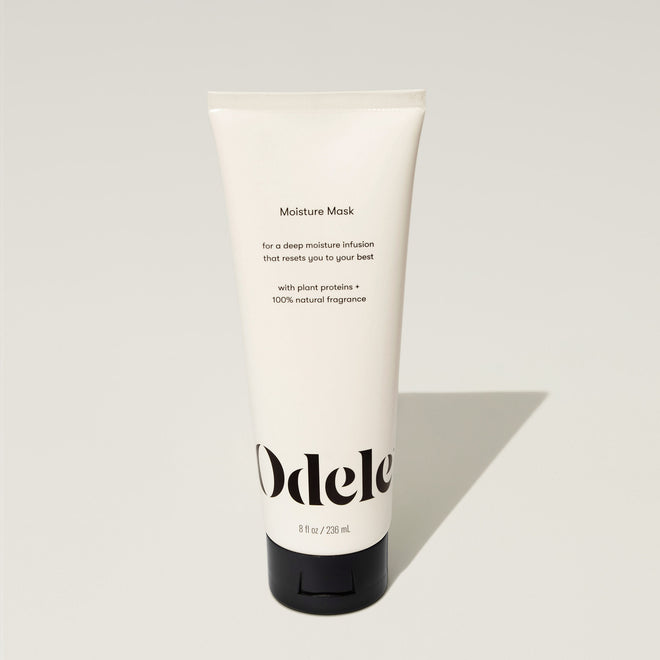 A tube of Odele Moisture Mask stands upright against a plain, light-colored backdrop with the front of the label facing the camera.