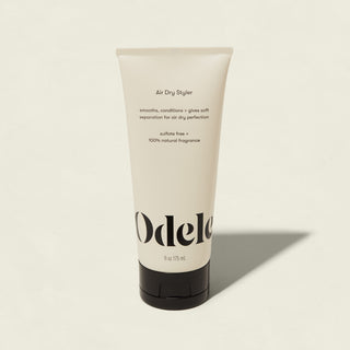 A 6 oz (175 mL) tube of Odele Air Dry Styler with black cap, labeled as smoothing, conditioning, anti-frizz, sulfate-free, salon-grade, and 100% natural fragrance sits on a light background.