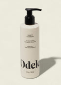 A white bottle of Leave-in Conditioner with a black pump, featuring deep moisture, frizz control, detangling, and sulfate-free care with 100% natural fragrance in an 8 fl oz (236 mL) size.