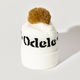 The Good Hair Day Winter Hat is a white knit beanie with a folded brim, black text, and a large brown pom-pom—expertly crafted for quality, comfort, and style.