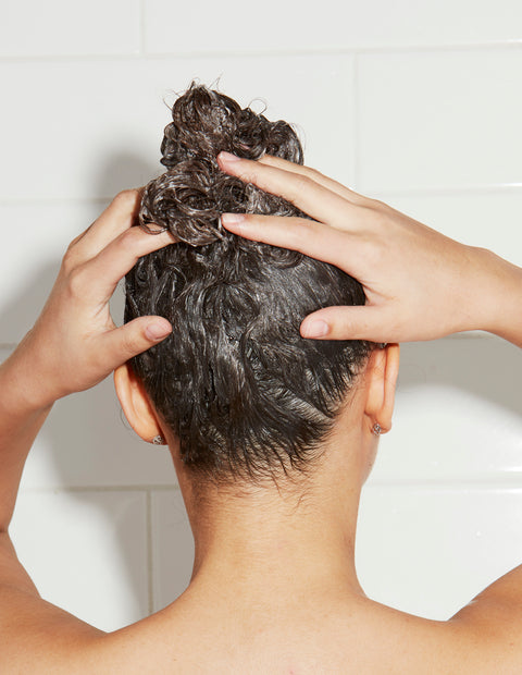 woman scrubbing wet hair