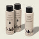 Three beige bottles from the Odele Ultra Sensitive Set—shampoo, conditioner, and body wash—stand upright on a light background. Their labels highlight that they are ultra sensitive and fragrance-free.