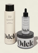 The Odele Scalp Care Set features a clarifying shampoo, rejuvenating scalp serum, and scalp scrub in minimalist black-and-white packaging with bold Odele branding.