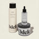 The Odele Scalp Care Set features a clarifying shampoo, rejuvenating scalp serum, and scalp scrub in minimalist black-and-white packaging with bold Odele branding.