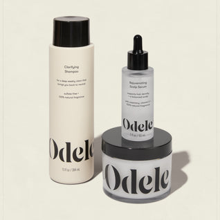 The Odele Scalp Care Set features a clarifying shampoo, rejuvenating scalp serum, and scalp scrub in minimalist black-and-white packaging with bold Odele branding.