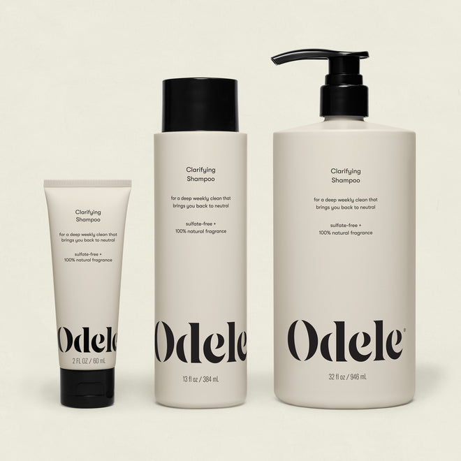 Three bottles of Clarifying Shampoo Bulk in 2 fl oz, 13 fl oz, and 32 fl oz are lined up against an off-white background. Each minimalist bottle features black text and black caps.