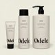Three bottles of Clarifying Shampoo Bulk in 2 fl oz, 13 fl oz, and 32 fl oz are lined up against an off-white background. Each minimalist bottle features black text and black caps.