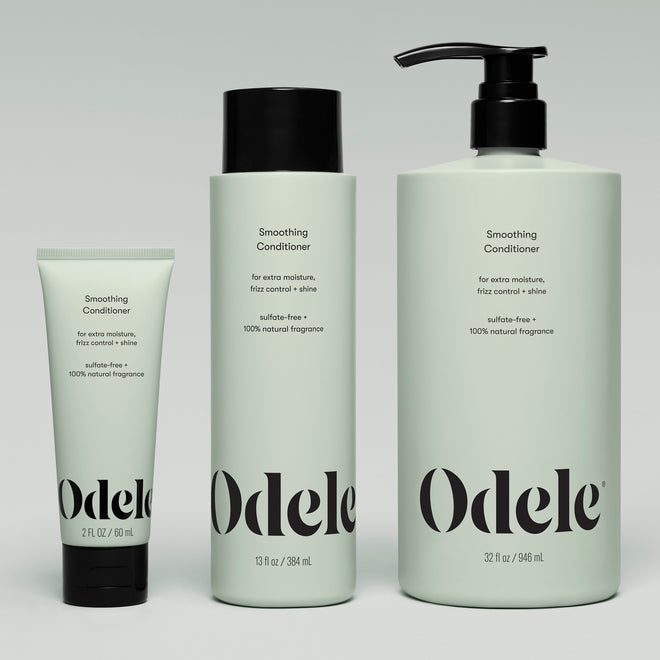 Three mint-green bottles of Smoothing Conditioner (2 fl oz, 13 fl oz, and 32 fl oz) are displayed side by side, labeled as sulfate-free with 100% natural fragrance for shine and frizz control.