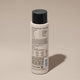 A bottle of Odele Ultra Sensitive Conditioner stands upright against a plain, light-colored backdrop with the back of the label facing the camera.