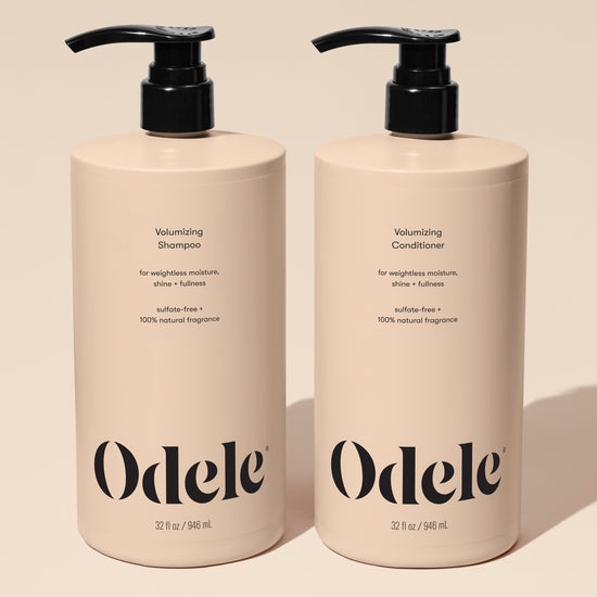 Two beige pump bottles of Volumizing Duo Bulk, each 32 fl oz, sit side by side on a neutral background, delivering max volume with weightless moisture, shine, and fullness.