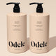 Two beige pump bottles of Volumizing Duo Bulk, each 32 fl oz, sit side by side on a neutral background, delivering max volume with weightless moisture, shine, and fullness.
