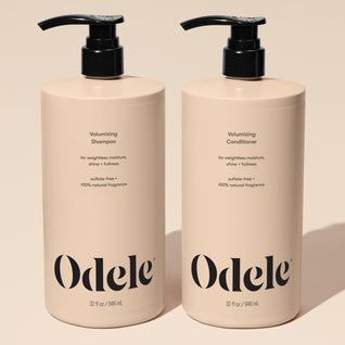 Two beige pump bottles of Volumizing Duo Bulk, each 32 fl oz, sit side by side on a neutral background, delivering max volume with weightless moisture, shine, and fullness.