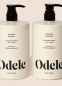 Bottles of Odele Volumizing Shampoo and Conditioner stand upright against a plain light-colored backdrop with the front of the label facing the camera.