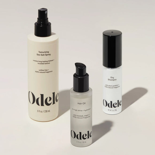 The Odele Long Live Bundle hair care products are arranged on a light beige surface.