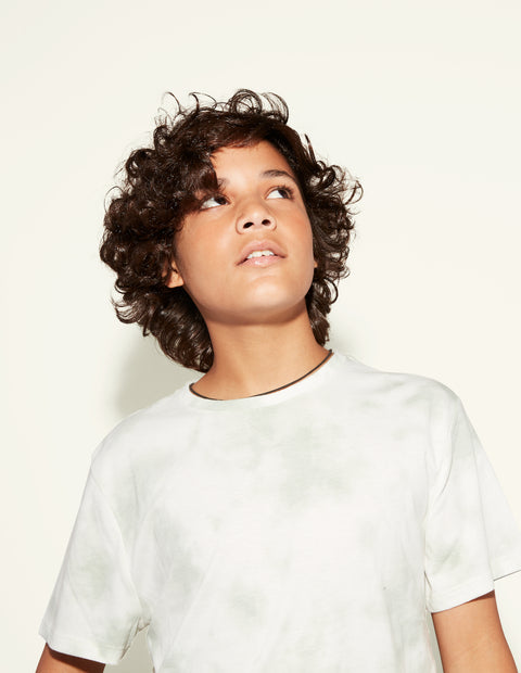 young person with short dark curly hair